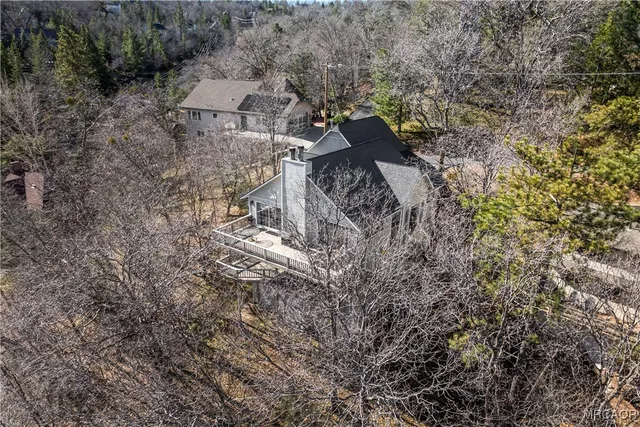 a front view of a house with a yard covered with snow