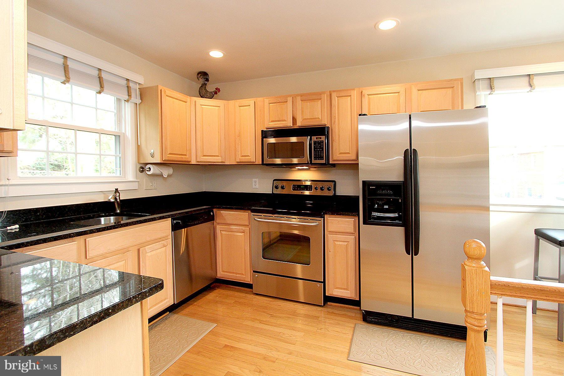805 Stirling Road Silver Spring, MD 20901 - Photo 16 of 29 a kitchen with stainless steel appliances a refrigerator sink and microwave
