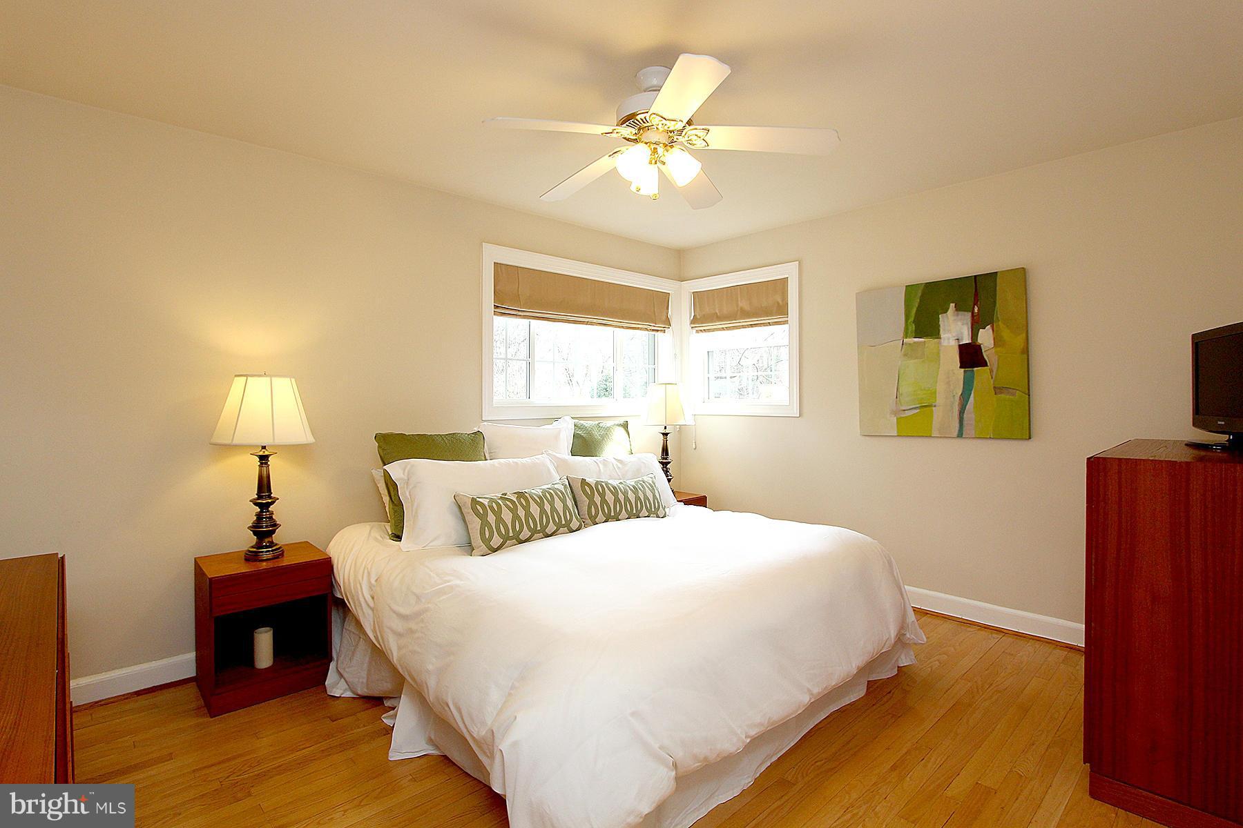 805 Stirling Road Silver Spring, MD 20901 - Photo 20 of 29 a bedroom with a bed and a chandelier