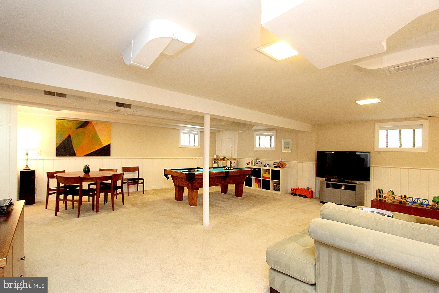 805 Stirling Road Silver Spring, MD 20901 - Photo 26 of 29 a living room with furniture and a flat screen tv