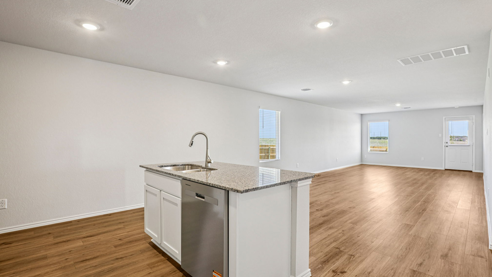 148 Wyatt Way Jarrell, TX 76537 - Photo 6 of 33 Open-concept living area featuring wood-finish flooring, recessed lighting, and ample natural light through multiple windows