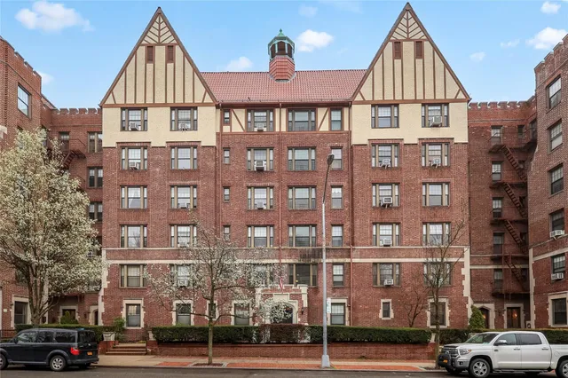a view of a brick building next to a road