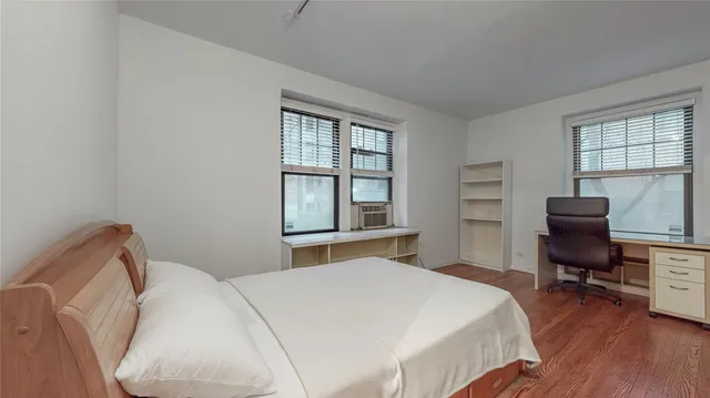 a bedroom with a bed and a desk