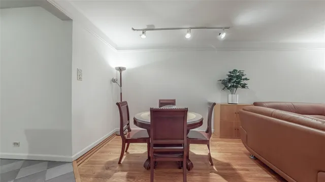 a dining room with furniture and a potted plant