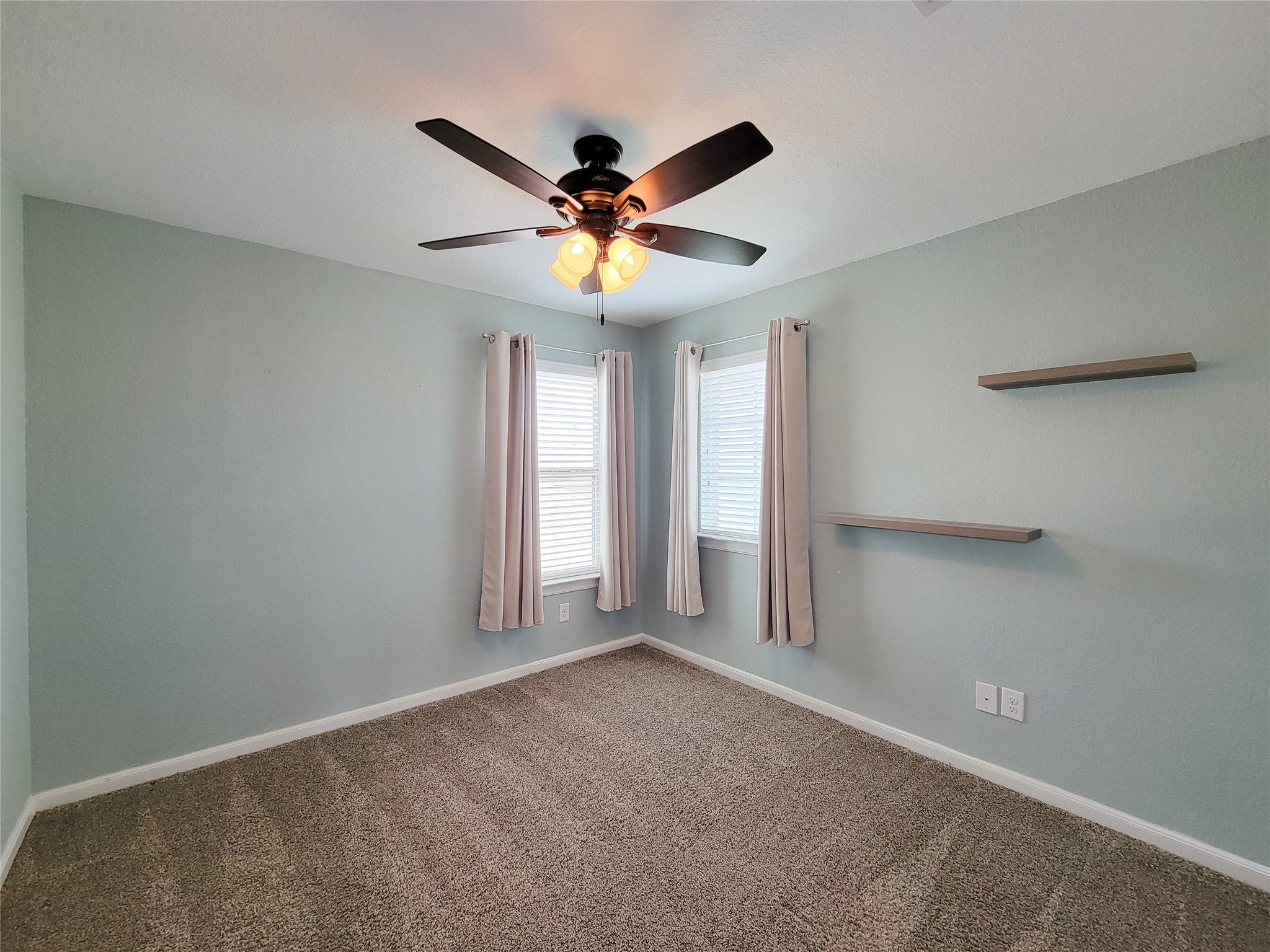 9726 Shimmering Lakes Drive Rosharon, TX 77583 - Photo 24 of 33 a view of an empty room with window and chandelier fan