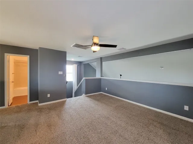 a view of a big room with closet and chandelier fan