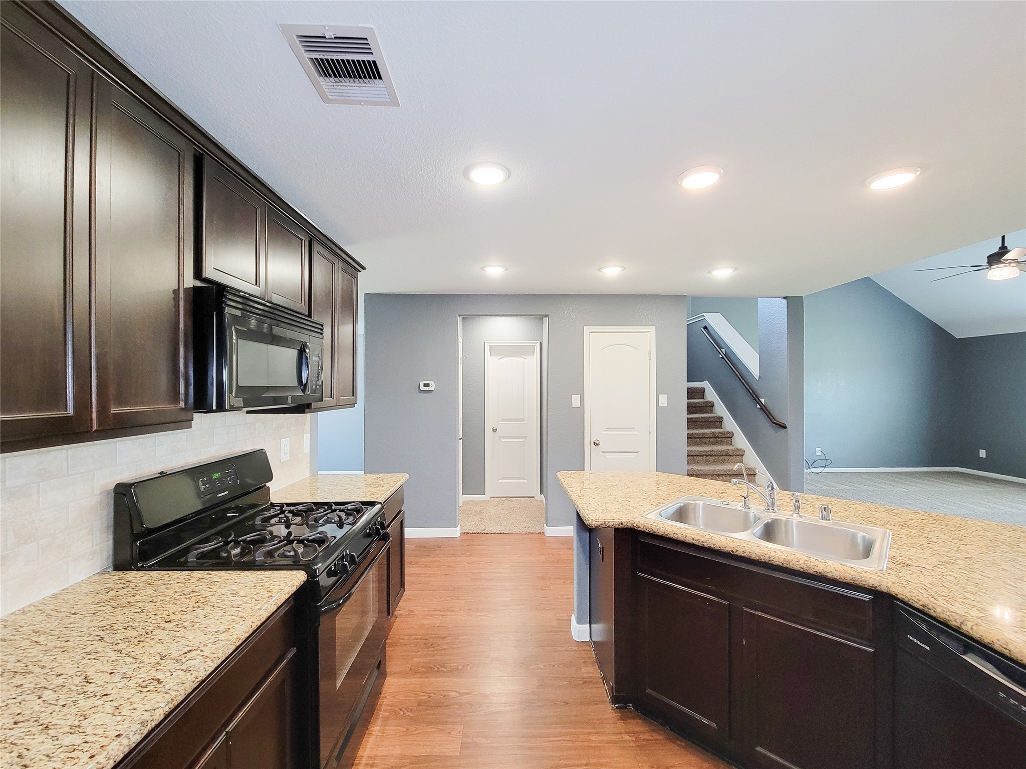 9726 Shimmering Lakes Drive Rosharon, TX 77583 - Photo 8 of 33 a kitchen with stainless steel appliances granite countertop a sink stove and refrigerator