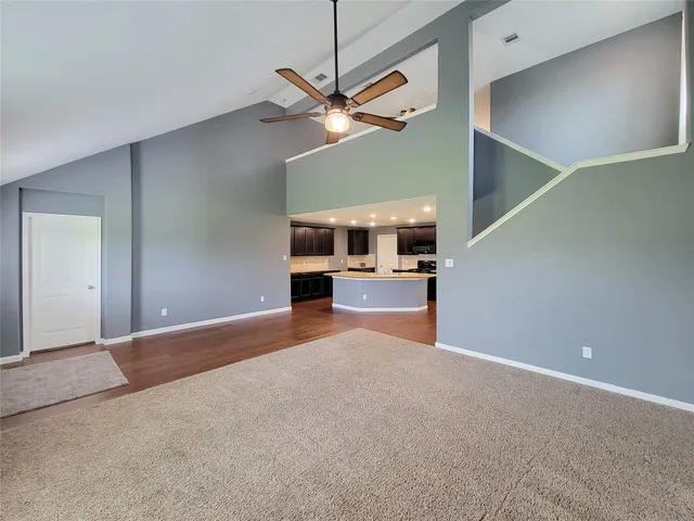 a view of a kitchen with a sink and a ceiling fan