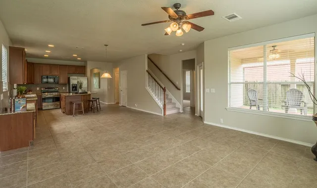 a kitchen with a sink a counter top space appliances and cabinets