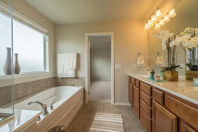a spacious bathroom with a sink mirror and shower