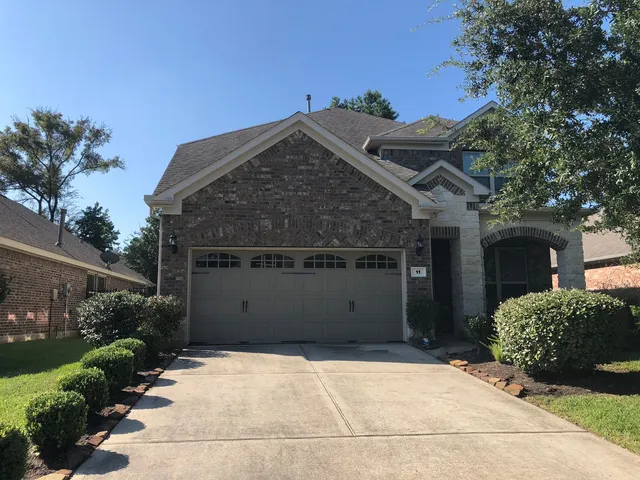 a view of a backyard with plants and a patio