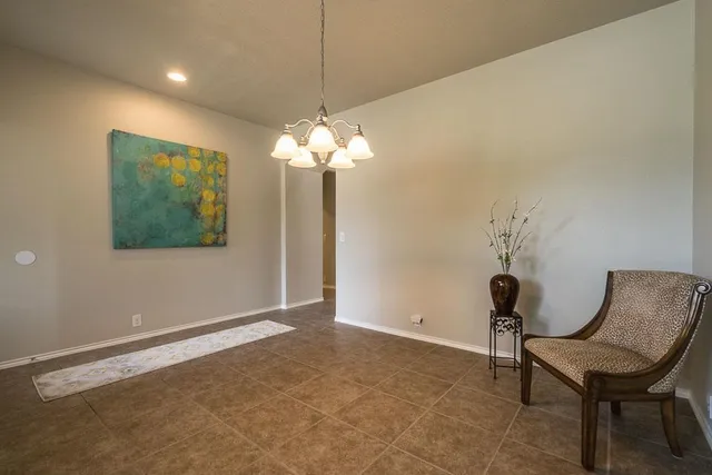 a view of a room with a chandelier fan and a rug