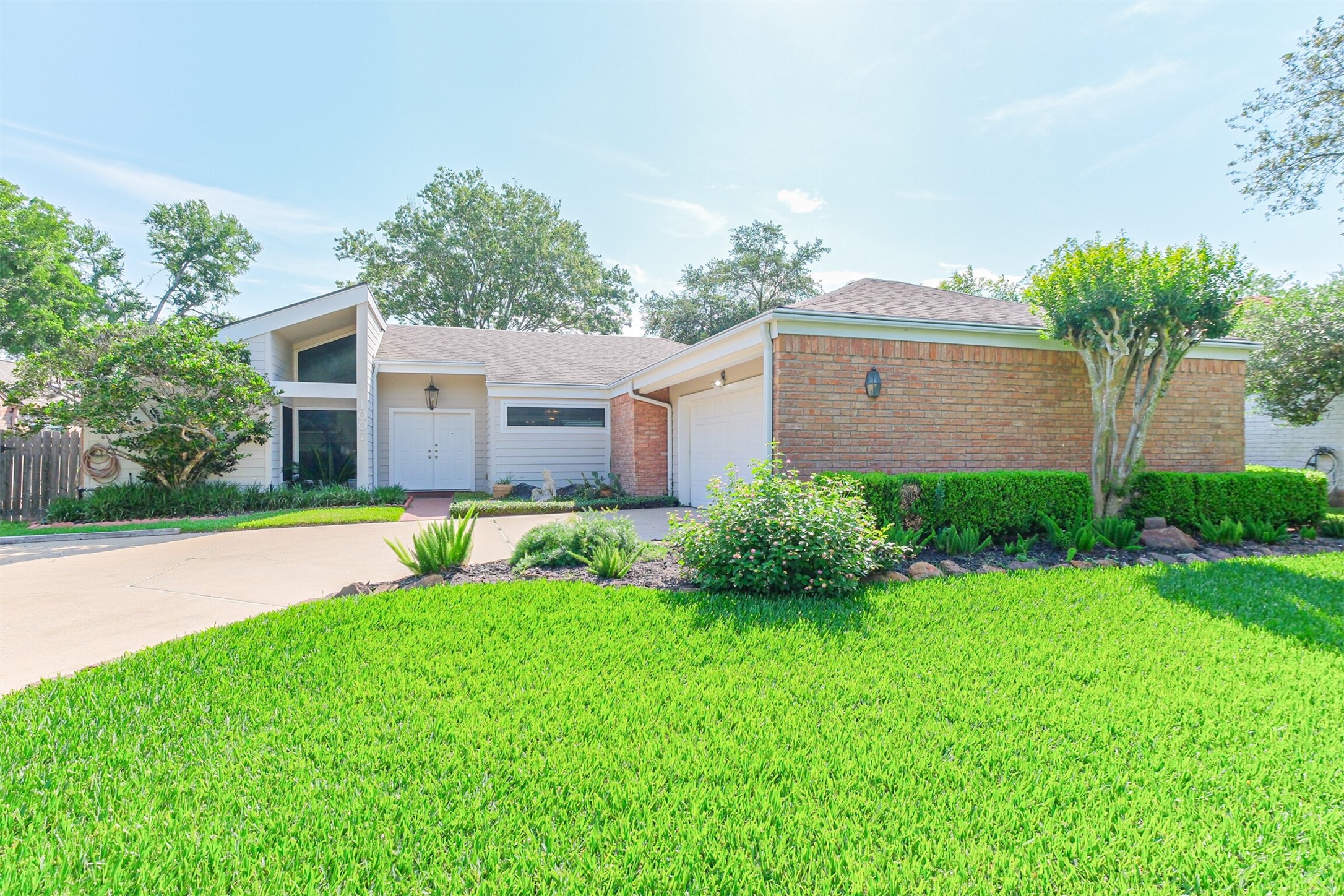 1007 Arrow Hill Road Houston, TX 77077 - Photo 2 of 48 The double wide driveway leads up to the 2 car attached garage with auto garage door opener.