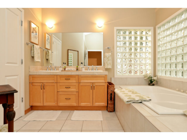 192 Seacliff Drive Aptos, CA 95003 - Photo 14 of 25 a spacious bathroom with a granite countertop sink a mirror a bathtub and next to a window