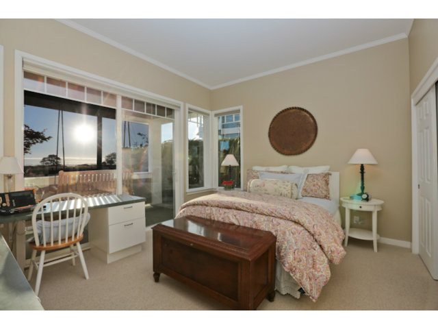 192 Seacliff Drive Aptos, CA 95003 - Photo 24 of 25 a bedroom with a bed and a chandelier