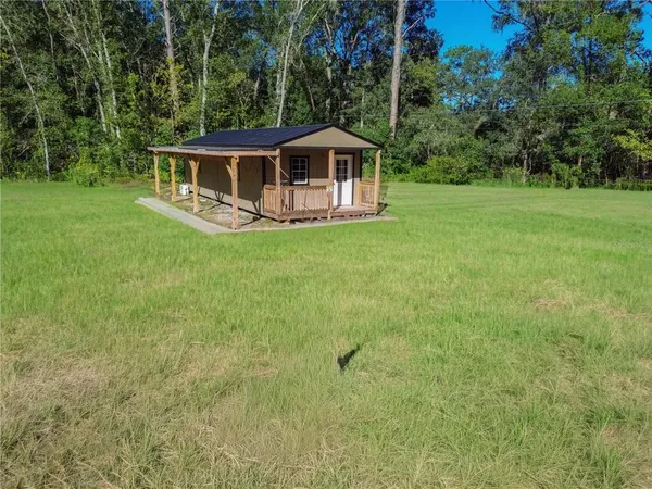 a view of a house with a backyard