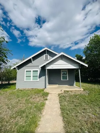 a front view of house with yard and trees