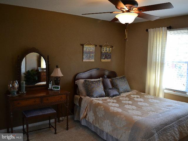 2106 Thomas View Road Reston, VA 20191 - Photo 14 of 29 a bedroom with a bed and a chandelier