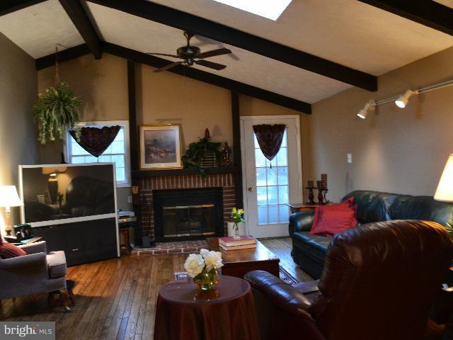 2106 Thomas View Road Reston, VA 20191 - Photo 20 of 29 a living room with furniture a flat screen tv and a fireplace