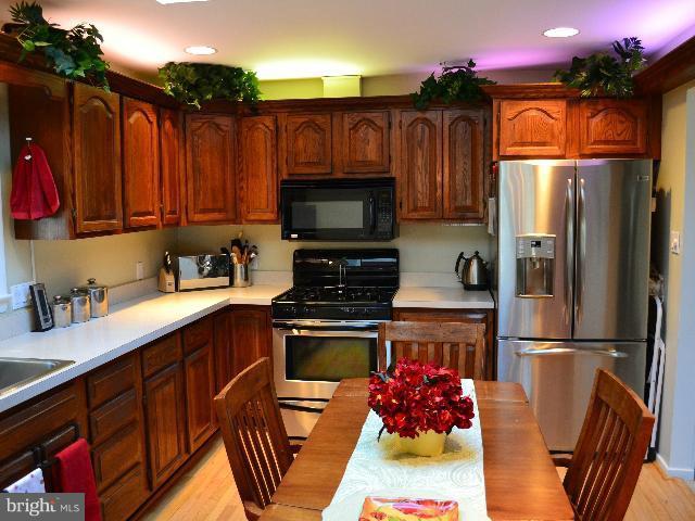 2106 Thomas View Road Reston, VA 20191 - Photo 4 of 29 a kitchen with stainless steel appliances granite countertop a refrigerator a stove top oven a sink and dishwasher