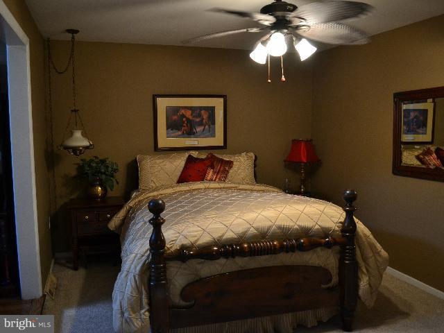 2106 Thomas View Road Reston, VA 20191 - Photo 8 of 29 a bedroom with a bed and a chandelier
