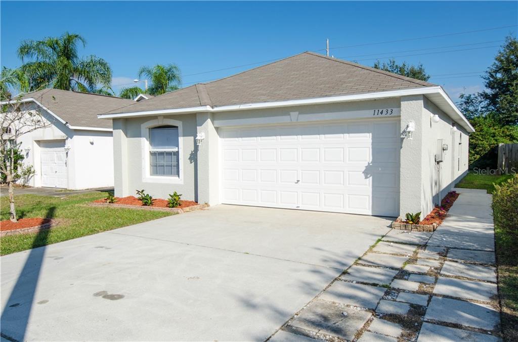 11433 Ivy Flower Loop Riverview, FL 33578 - Photo 1 of 1 a front view of a house with a yard and garage