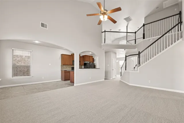 a kitchen with stainless steel appliances granite countertop a refrigerator a stove and a sink with wooden cabinets