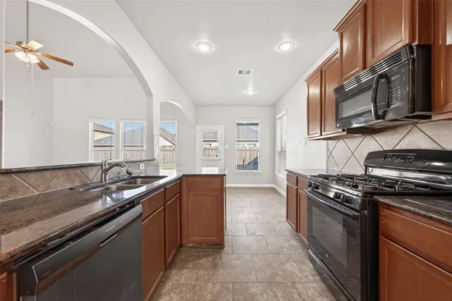 a kitchen with a sink and a stove