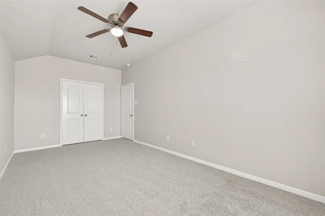 a view of a house with wooden fence and a fence