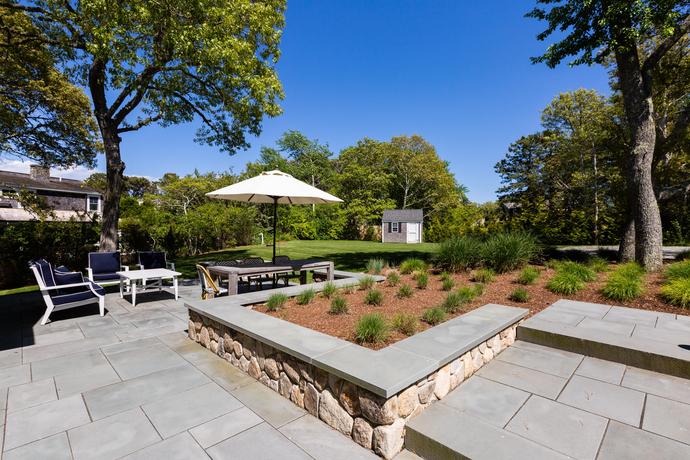 60 Tappan Drive Chatham, MA 02633 - Photo 6 of 46 a view of a chairs and table in the patio with a fire pit