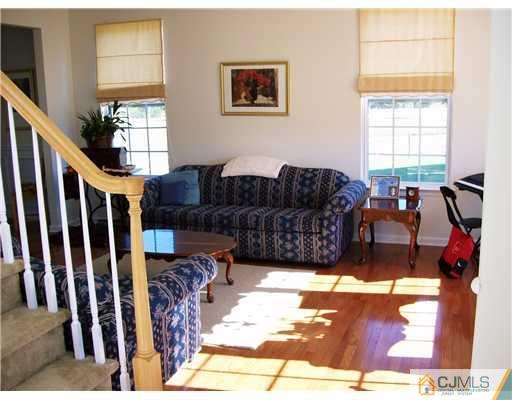 26 Carnation Road Monroe Township, NJ 08831 - Photo 3 of 10 a living room with furniture a bed and a window