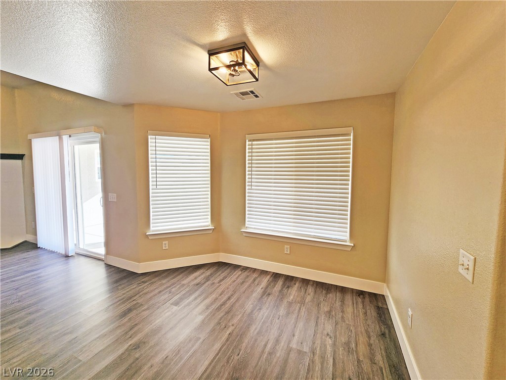 4591 Stoneham Street Pahrump, NV 89061 - Photo 14 of 42 Natural light floods this inviting living space, highlighting its elegant flooring and pristine walls.