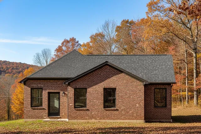 a view of house with backyard