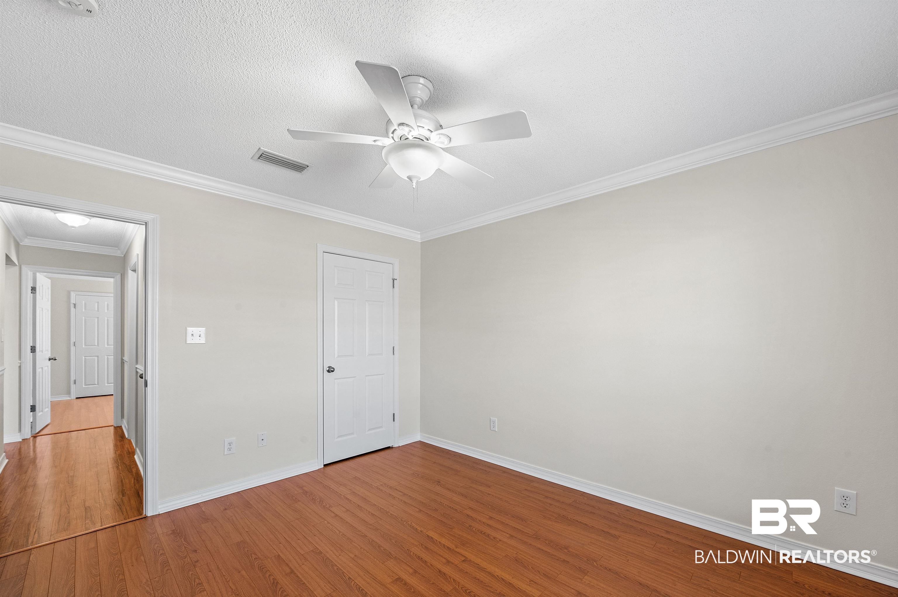 421 Collinwood Loop Foley, AL 36535 - Photo 46 of 62 Unfurnished bedroom with ornamental molding, a textured ceiling, light hardwood / wood-style floors, and ceiling fan