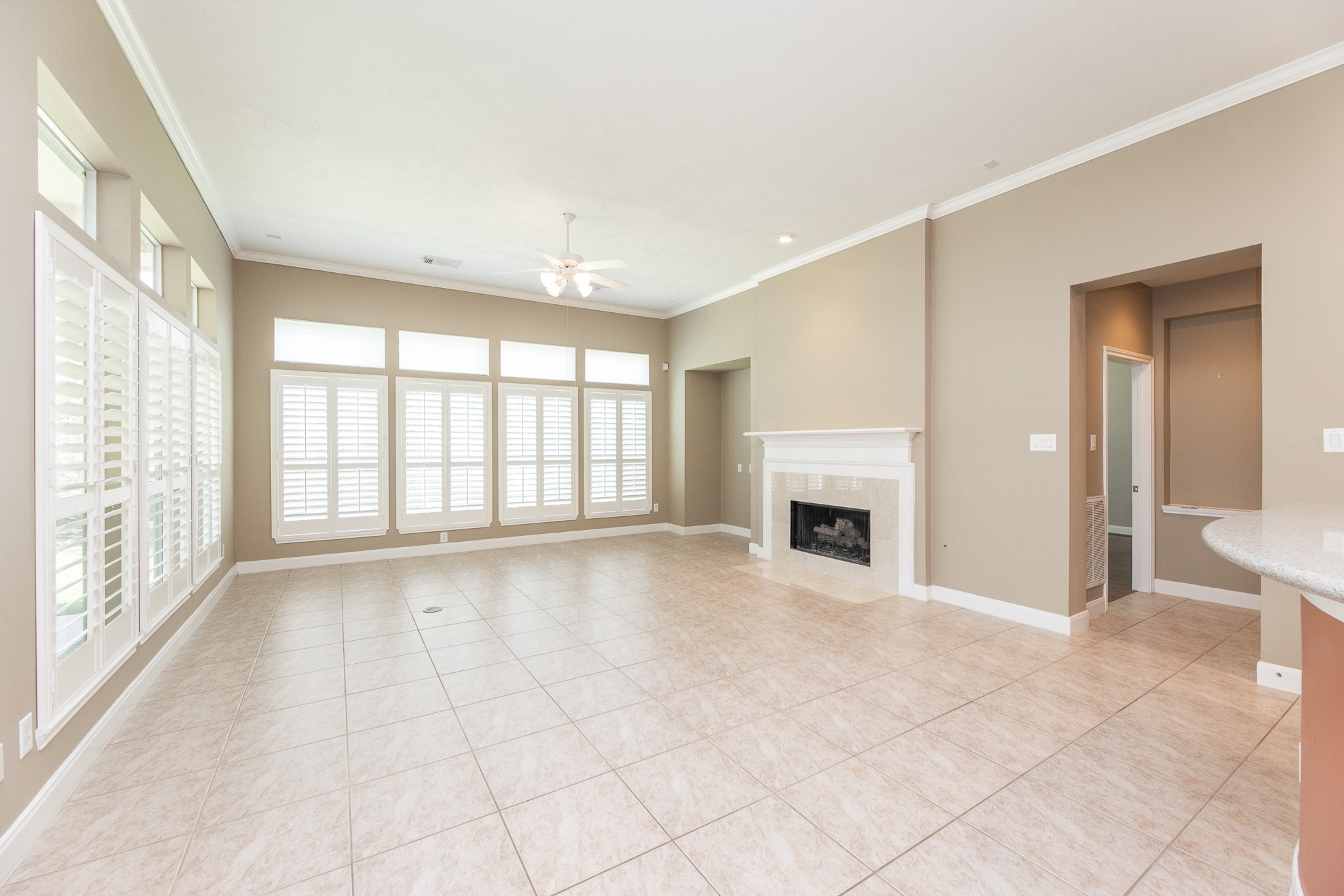 1222 Brinson Court Spring, TX 77379 - Photo 12 of 35 a view of an empty room with a fireplace and a large window