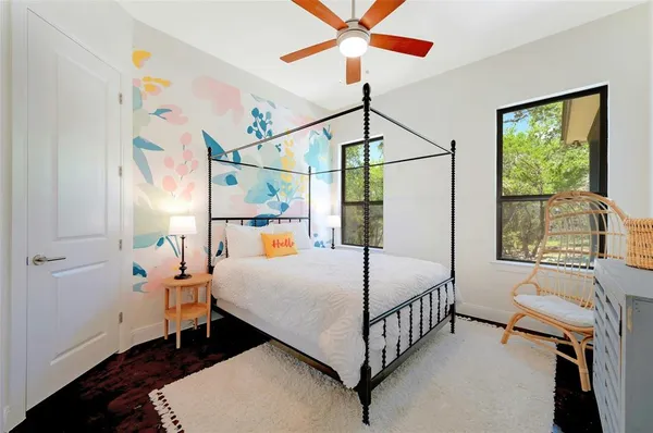 a bedroom with a bed a window and couch