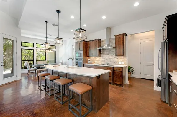 a large kitchen with a table and chairs