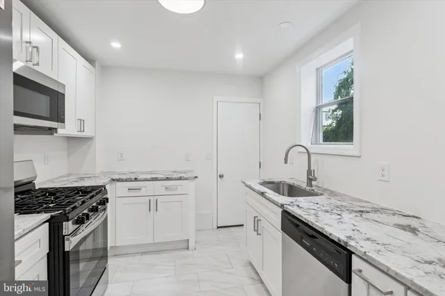 a kitchen that has a sink and a stove
