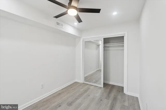 a bathroom with a sink a light fixture and a toilet