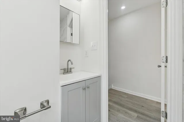 a bedroom with a bed a chandelier and a window
