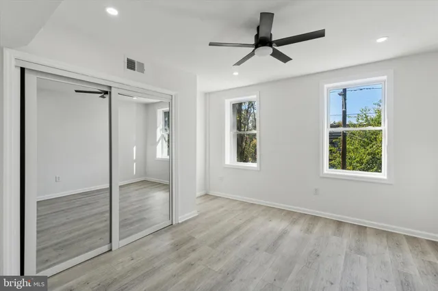 a view of empty room with wooden floor