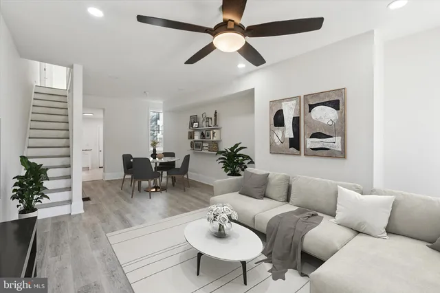 a living room with furniture and a potted plant