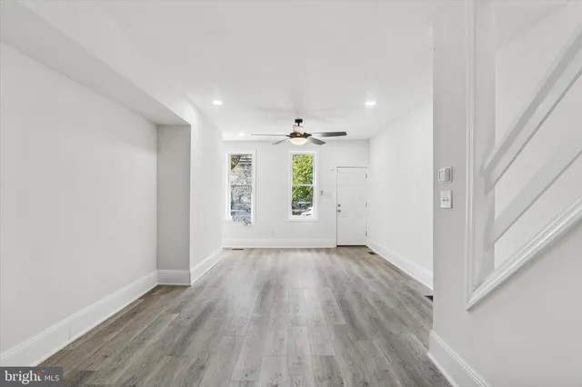 wooden floor in an empty room with a window