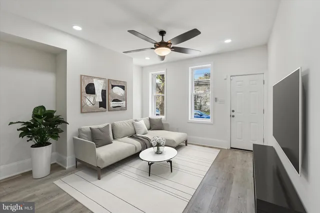 a living room with furniture and a large window
