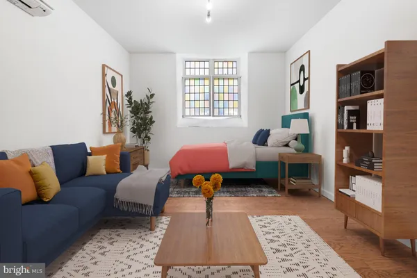 a living room with furniture rug and window