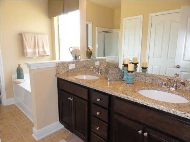 Lot 277 Riverbirch Loop Santa Rosa Beach, FL 32459 - Photo 7 of 8 a bathroom with a granite countertop sink and a mirror
