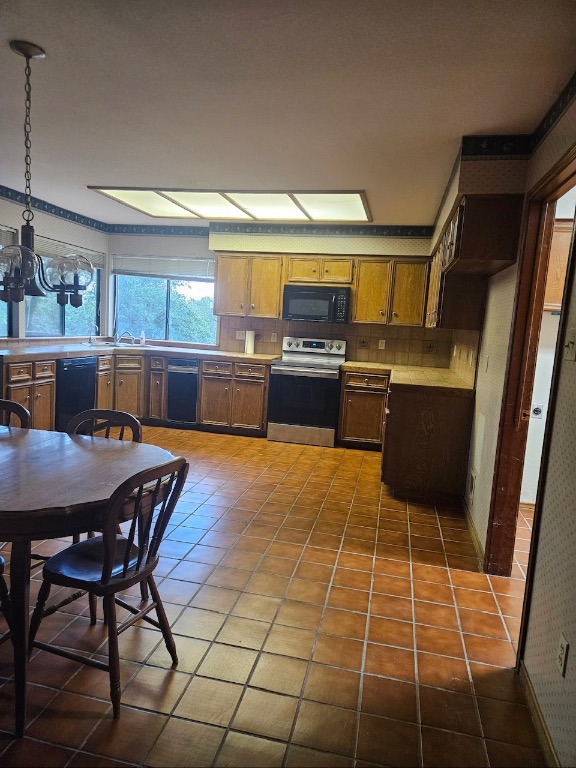 319 Fawnridge Street Georgetown, TX 78628 - Photo 9 of 24 a kitchen with stainless steel appliances a stove a sink a dining table and chair