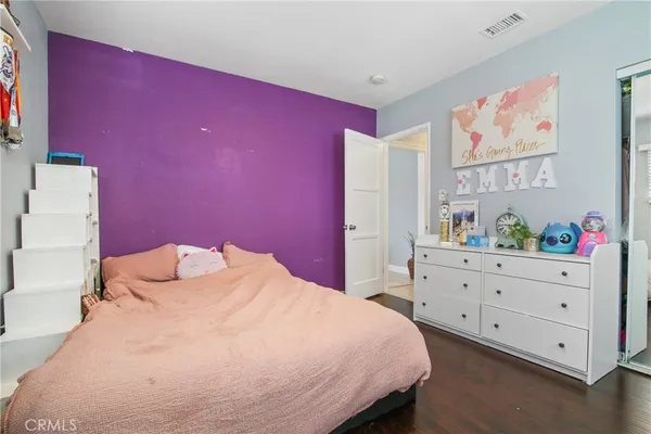 a bedroom with a bed and a dresser