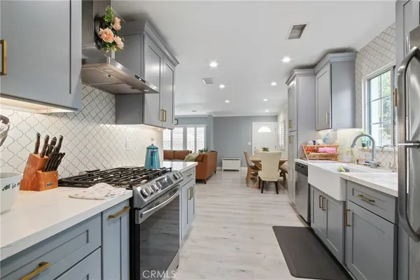 a kitchen with lots of counter top space view and stainless steel appliances