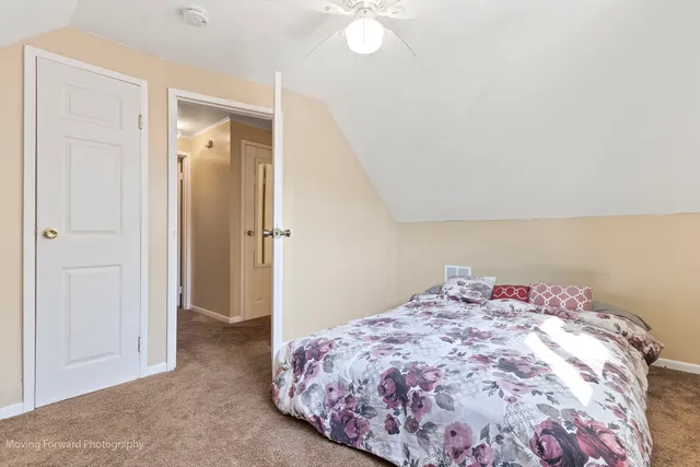 a bedroom with a bed and a dresser